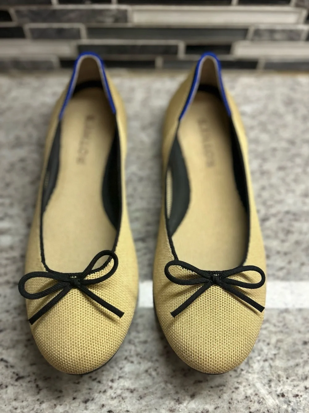 Rothy's Tan/cream Ballet Flats with Black Bow Trim and Blue Piping size 8